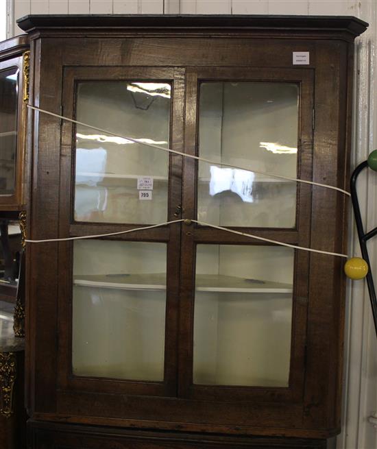 George III oak hanging corner cupboard with a pair of glazed square panelled doors